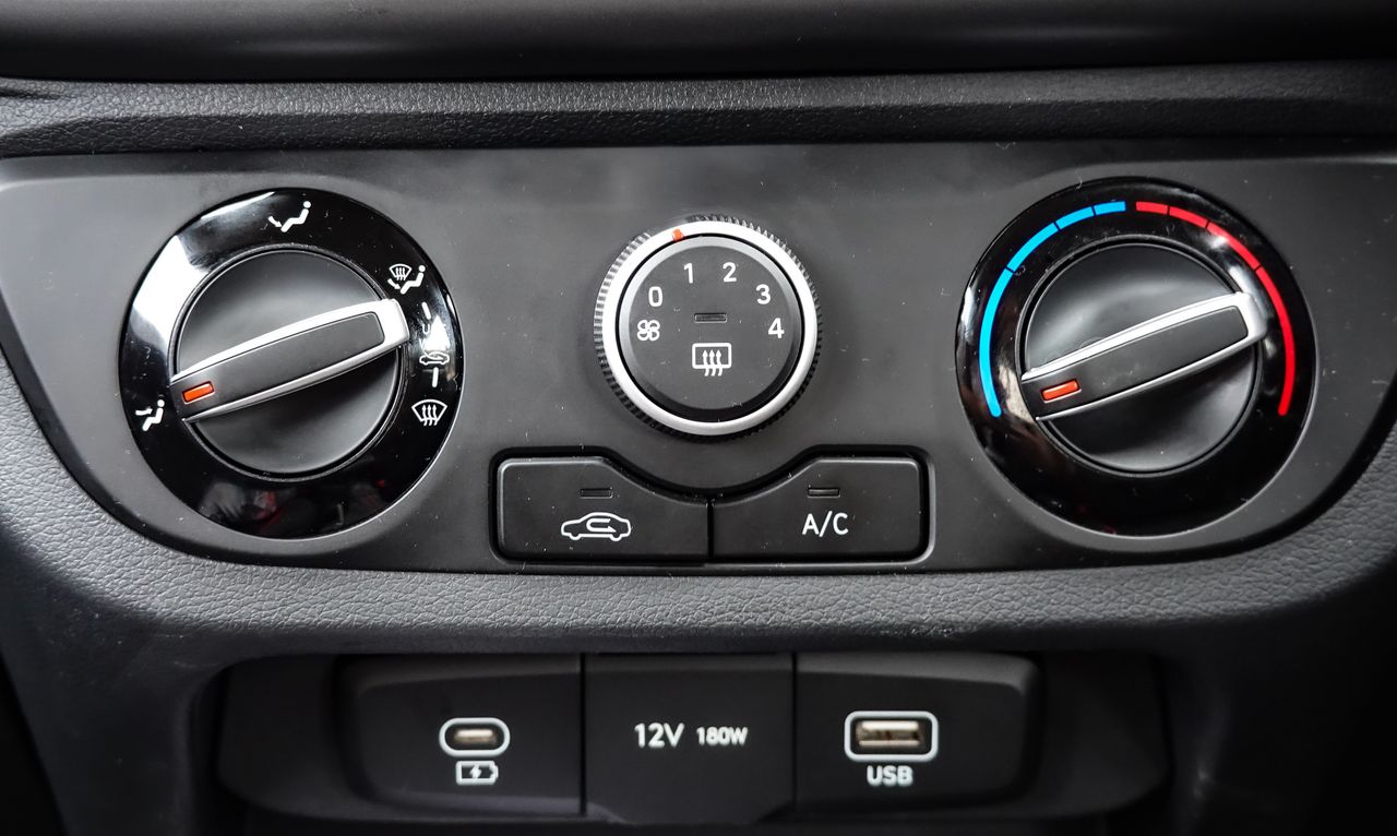 gallery-01 Close-up view of car air conditioning and dashboard controls, featuring climate settings and connectivity ports.