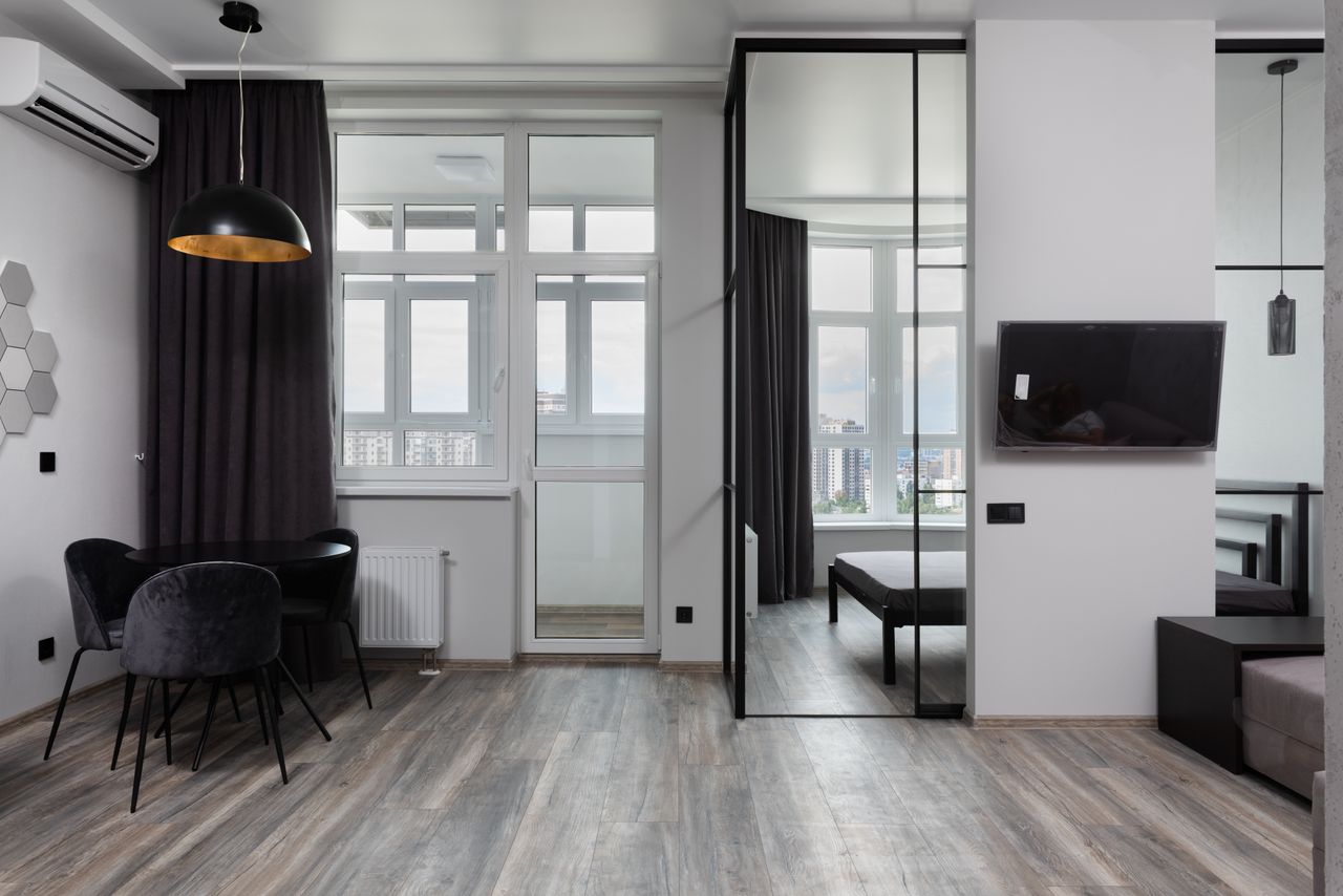 about-me-img Contemporary room interior with chairs under lamp and air conditioning in light house with glass wall